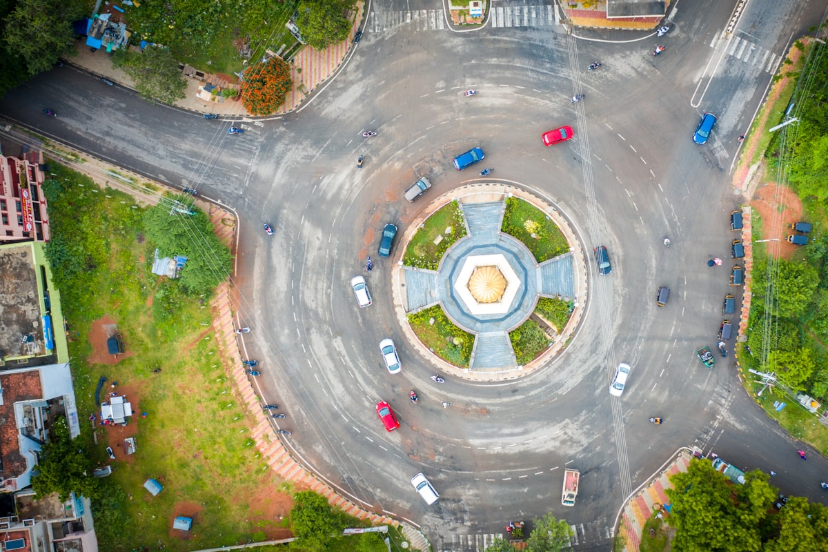 Top-down aerial view of a roundabout junction with vehicles